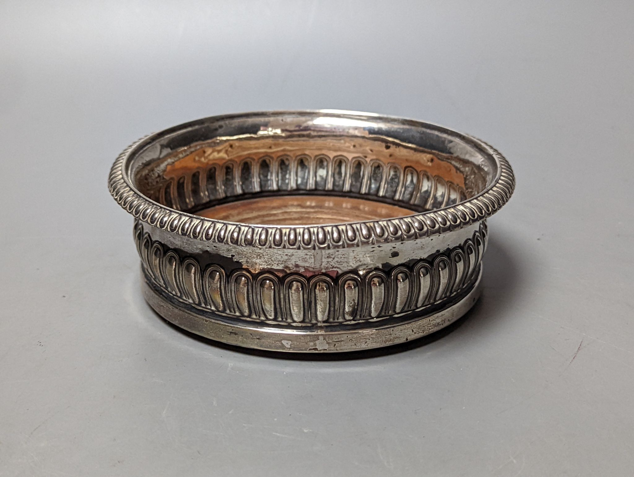 A George III demi fluted silver mounted wine coaster, John Roberts & Co, Sheffield, 1812, diameter 14.7cm.